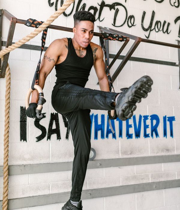 Man performing a controlled strength exercise with focused expression.